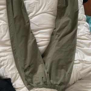 Green Nike track pants. Slim fitting.